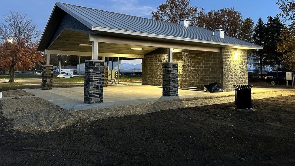 Completed park pavilion and restroom facility at dusk - CPM Construction project